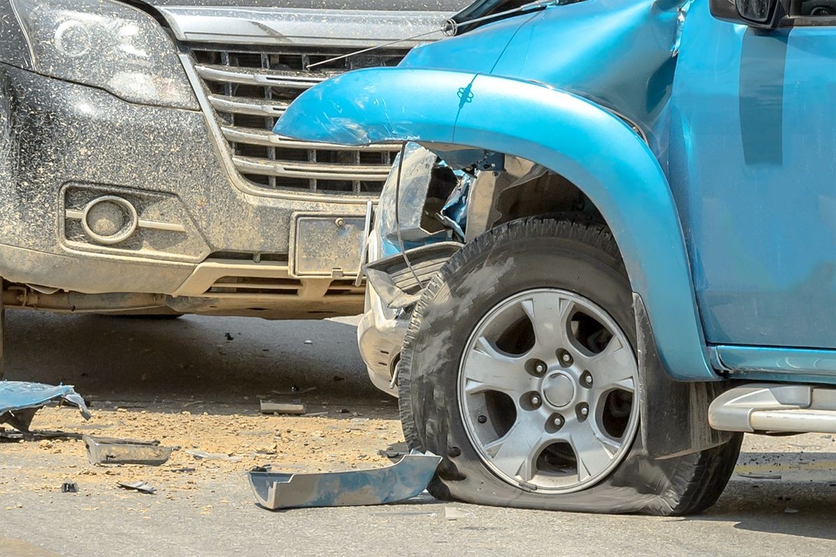 Car crash from car accident on the rural road between saloon and pickup wait insurance.