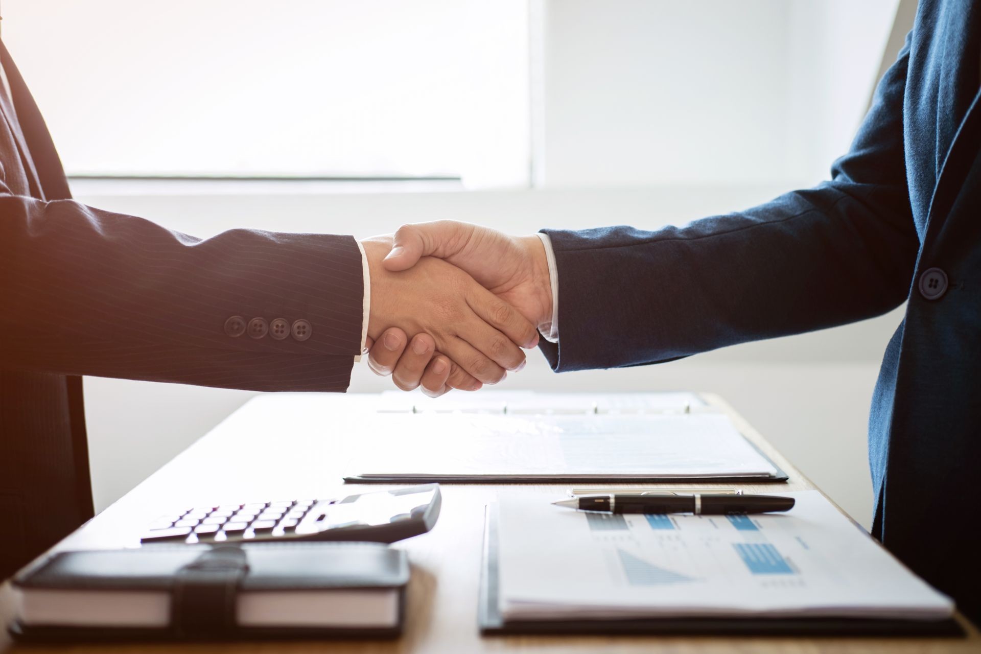 Finishing up a meeting, handshake of two happy business people after contract agreement to become a partner, collaborative teamwork.